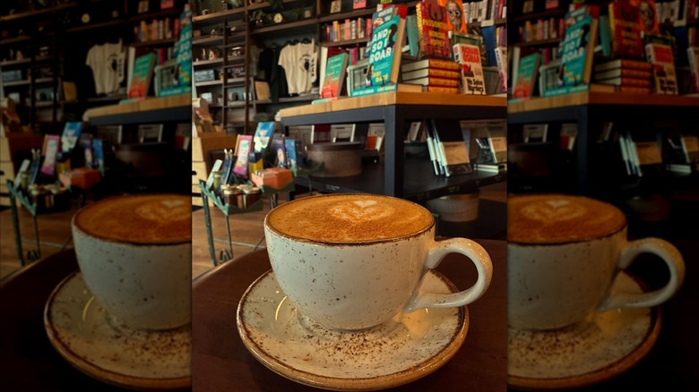 coffee in a mug in front of book shelves