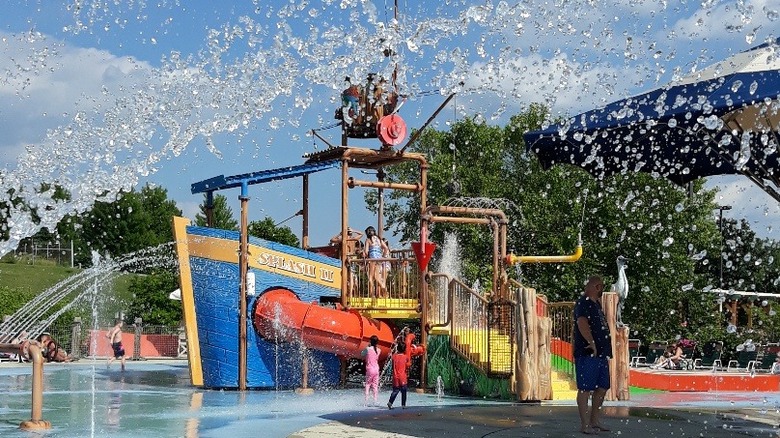 Water splashing and children playing at an aquatic playground at Cypress Cove Family Aquatic Park in Illinois