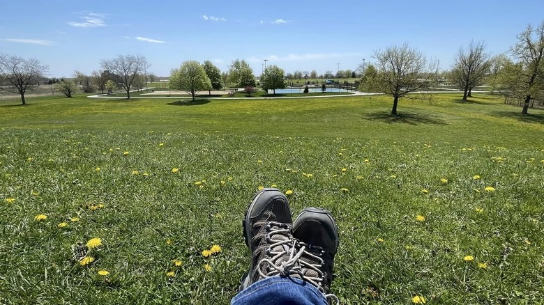 POV of feet sitting in grassy field in Homer Glen's Heritage Park in Illinois