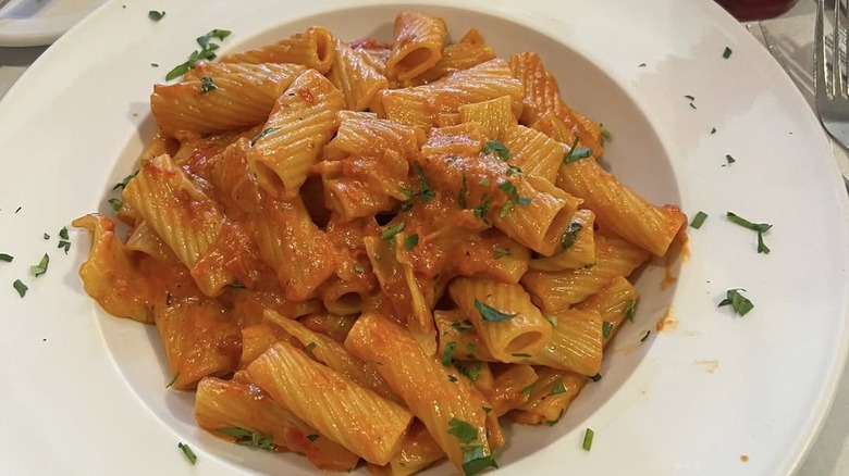 Rotini pasta with red sauce in white bowl