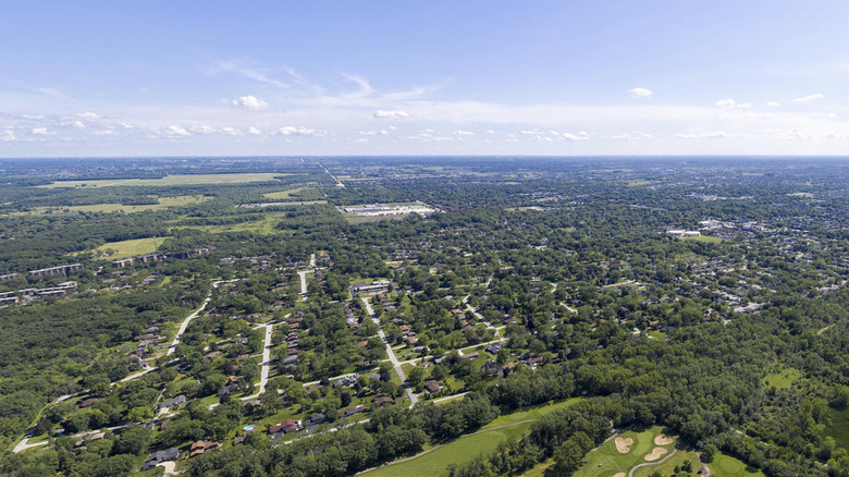 An aerial view of Oak Forest suburb and George W. Dunne National golf course on a sunny day