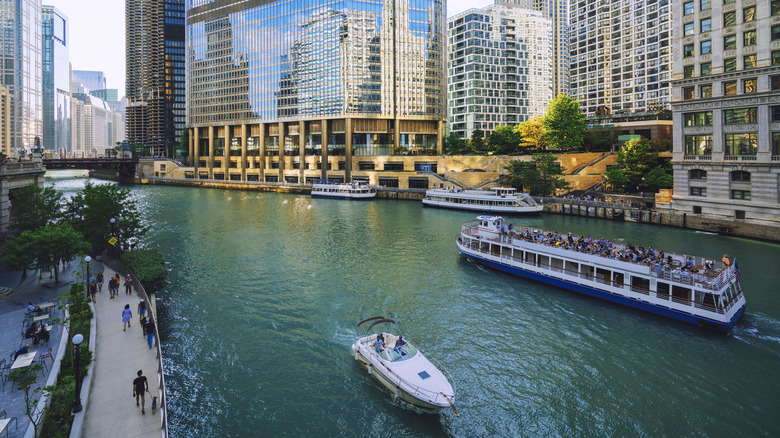 A boat passes a river cruise tour on the Chicago River