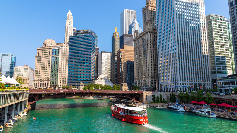 The red Chicago Fireboat Cruise heading under a bridge