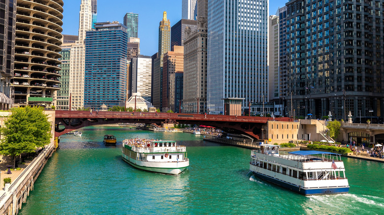 Sightseeing cruises pass by one another on the Chicago River