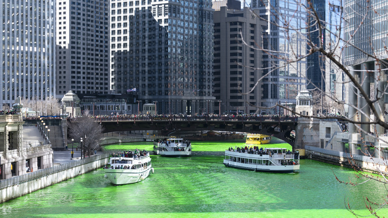Sightseeing boats on the green Chicago River during St Patricks Day