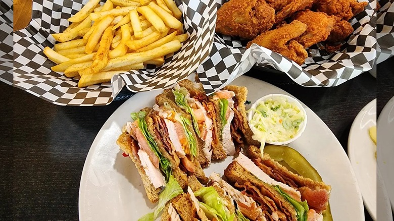 A sandwhich, french fries and fried chicken from Daley's