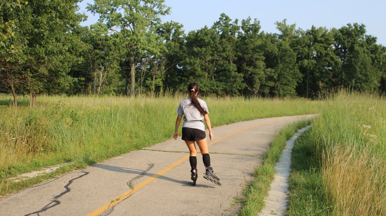 Girl on roller blades on a path along Morton Grove, Illinois
