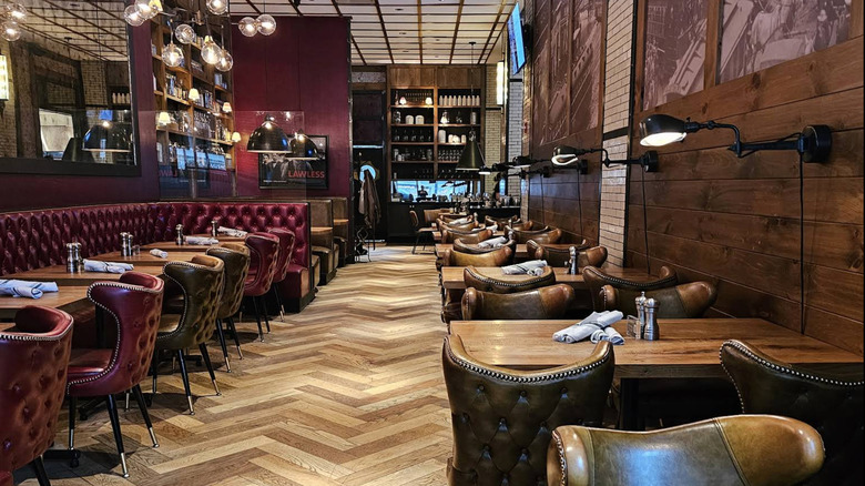 The interior of the Dearborn in Chicago, showing tables with leather chairs and booths.