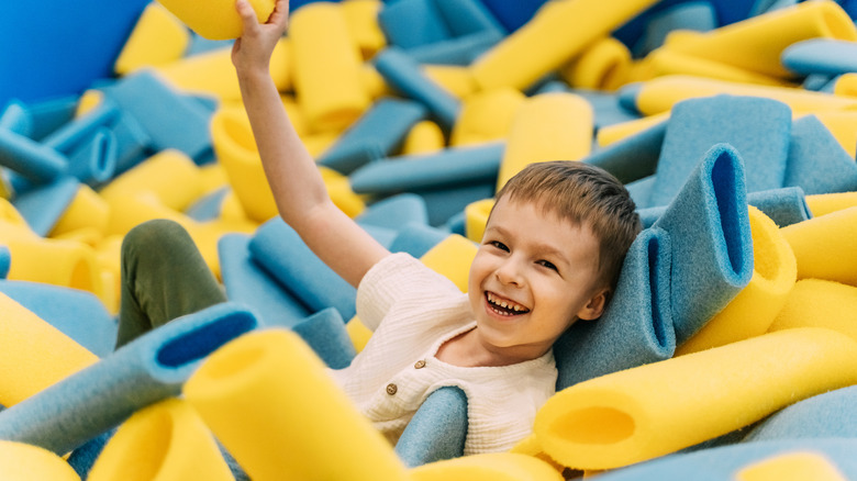 Boy smiling in an indoor playground