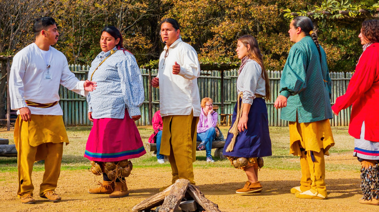 Members of the Chickasaw Nation standing in a line to demonstrate traditional dances