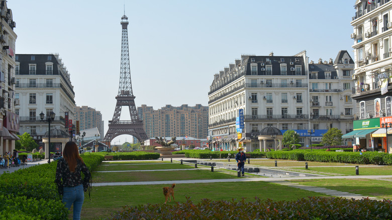 A replica Eiffel Tower stands in the distance of a fake French town in Tianducheng