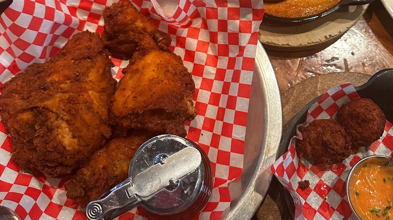 Plate of fried chicken, with hush puppies on the side