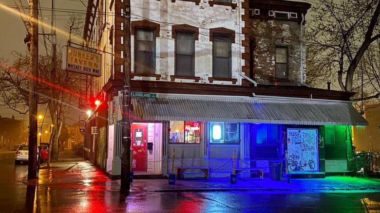 A tavern at night with colorful lights reflecting