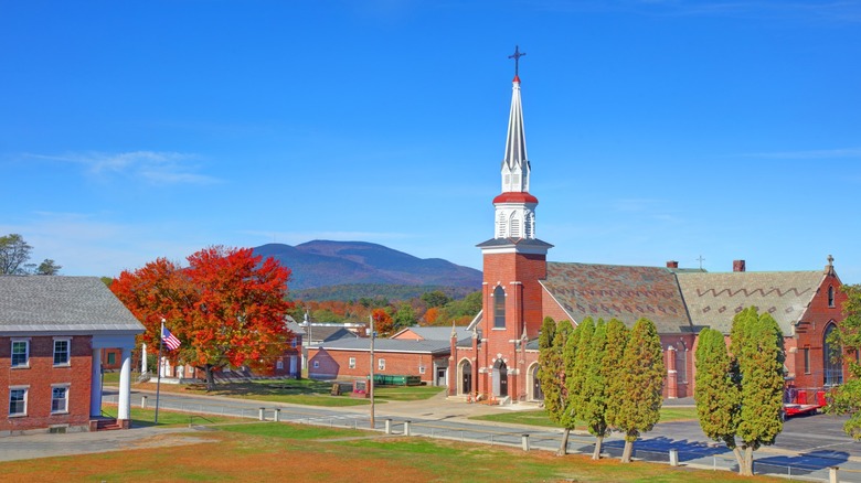 A view of Claremont, New Hampshire, with fall foliage in the foreground and mountains in the background