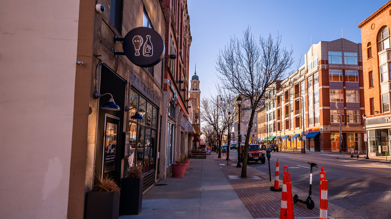 sidewalk next building and orange cones under blue sky