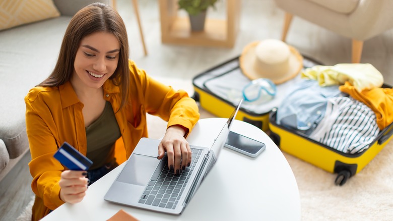woman uses travel credit card 