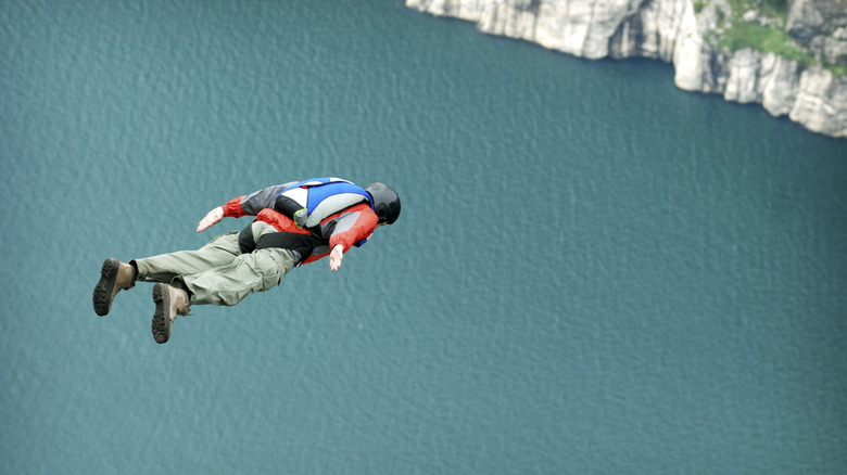 A person free-falls face-first during a BASE jump