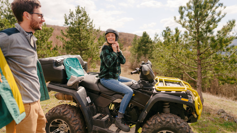 Couple going ATVing in forest