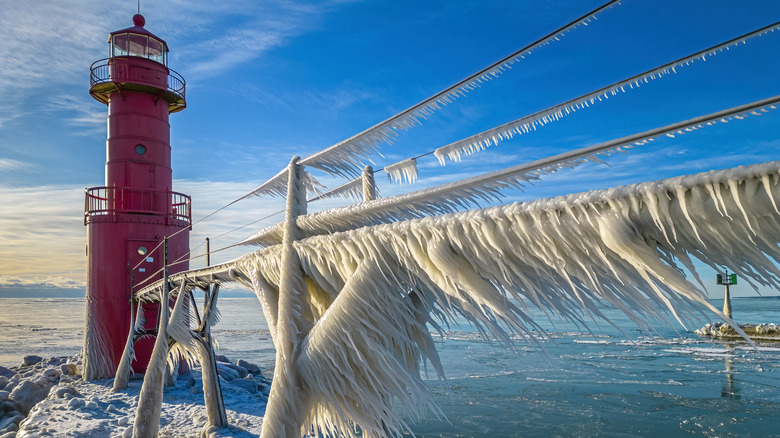 Amazing icy scenic harbor with lighthouse, Lake Michigan in Winter