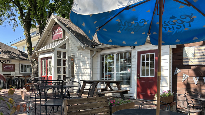A white restaurant storefront with outdoor patio seating in College Hill Wichita