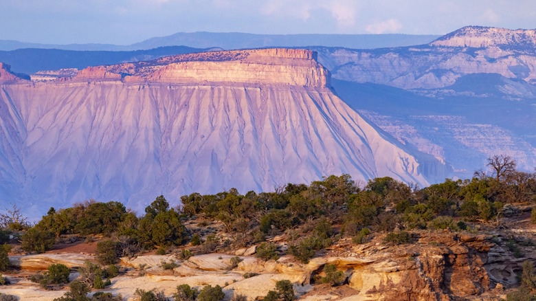 A distant view of Colorado National Monument during sunset, near Grand Junction