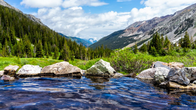Hot springs on Conundrum Creek Trail in Aspen, Colorado, with a view of mountains and trees in the background