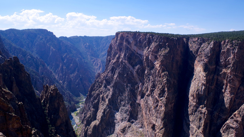 A cliff descends steeply into the Black Canyon of the Gunnison
