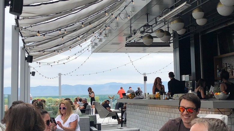 Rooftop bar with views of the Rocky Mountain in background