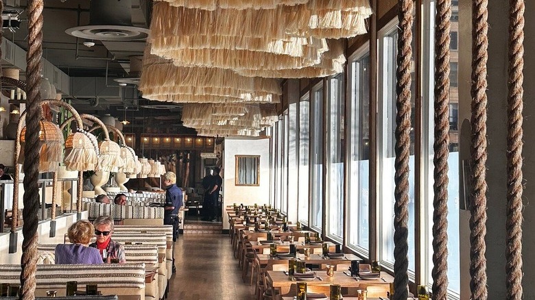 Dining room with glass windows and rustic decor