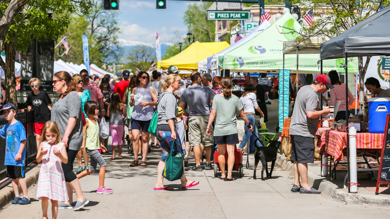Adults and children browsing the local stalls at the Parker Farmers Market