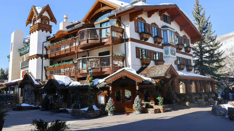 A building in Vail with distinctly Swiss influences and snow on the roof and background