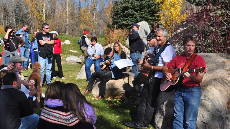 John Denver fans and friends gather for an informal memorial concert at the John Denver Sanctuary in Aspen, Colorado