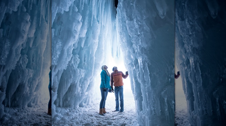 A couple entering a large ice cave