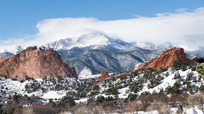 Snow-capped summit of Pikes Peak rising above Colorado rock formations