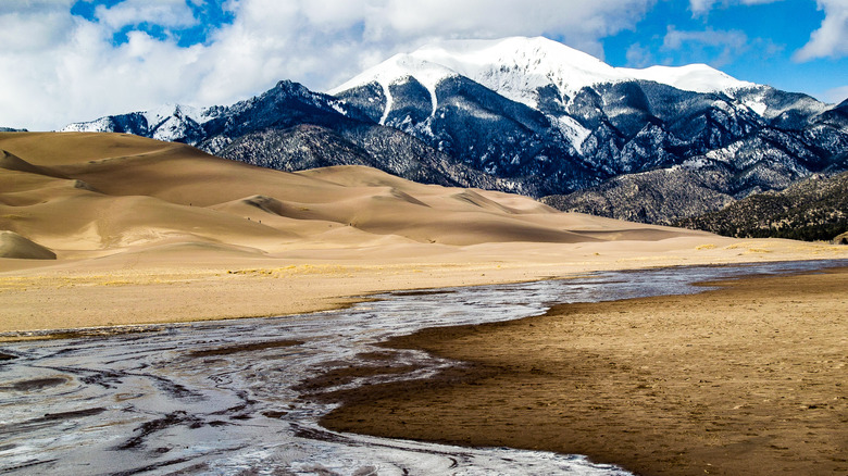 Snowmelt water flowing in the Great Sand Dune National Park with the Sangre de Cristo mountains in the background