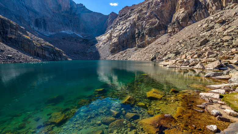 Rocky peaks surround Chasm Lake's clear, turquoise waters.
