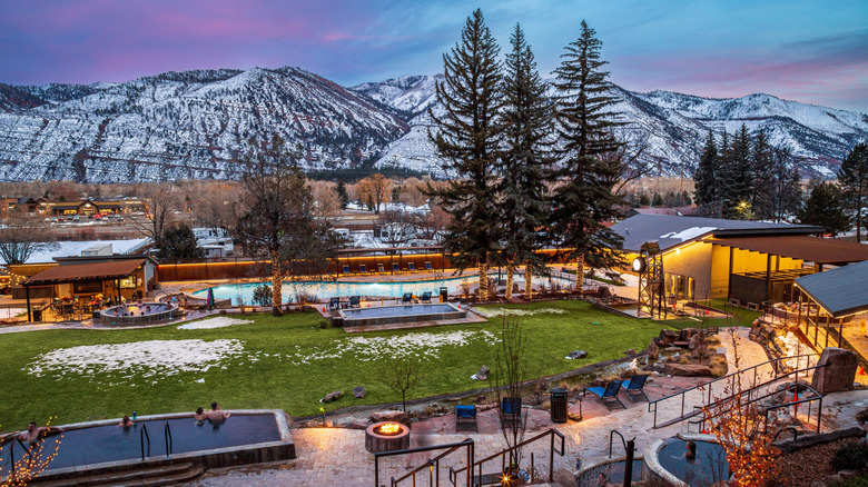 A wide view of the hot springs, pools, and gardens with snow-capped mountains in the distance at Durango Hot Springs Resort and Spa