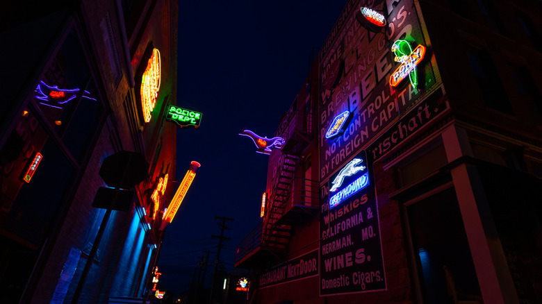 Glowing neon signs installed along the facade of Neon Alley, a public art installation in Pueblo, Colorado