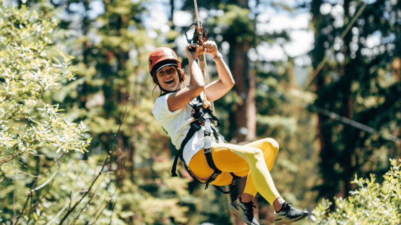 Woman riding zipline at The Lost Forest