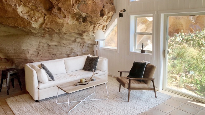A living room with a canyon cliffside as one wall