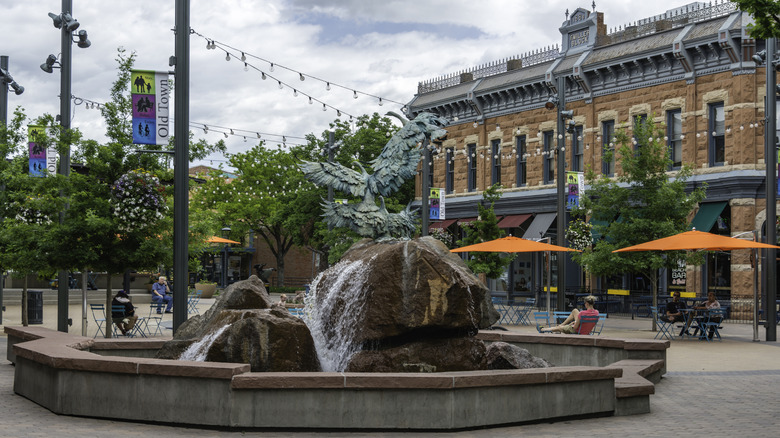 Old Town Square in Fort Collins, Colorado, with a fountain and an old building in the background