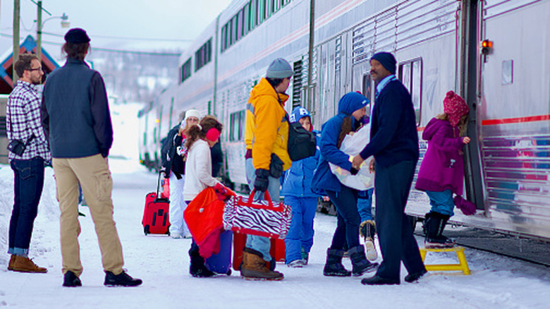 Families getting on a California Zephyr train at the Winter Park Ski Resort in the Rocky Mountains, Colorado