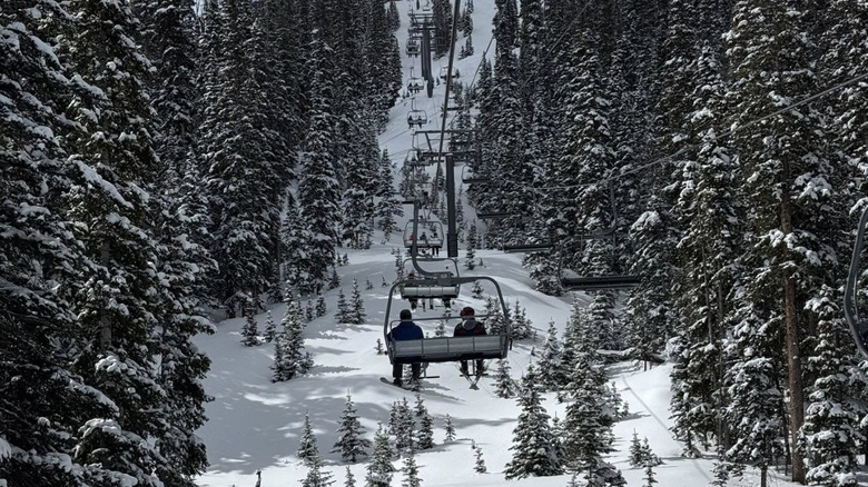 Skiers relax on the ski lift in Telluride, Colorado