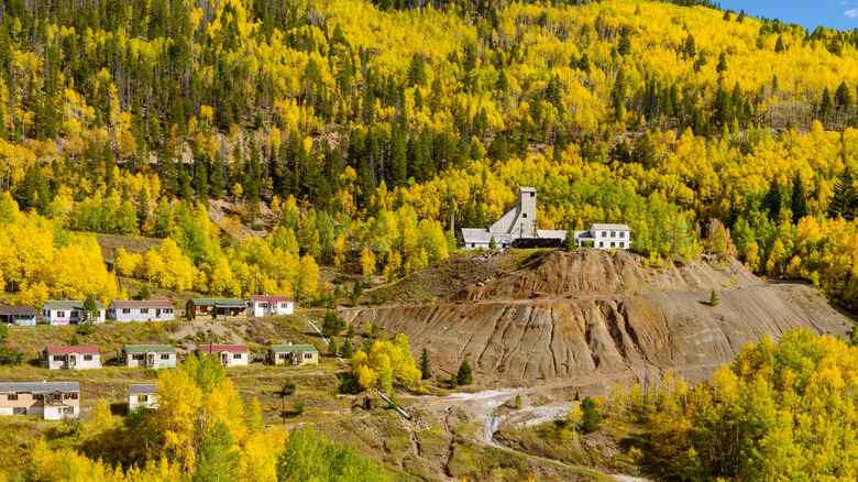 A distant landscape of Gilman, Colorado surrounded by autumn-tinted trees