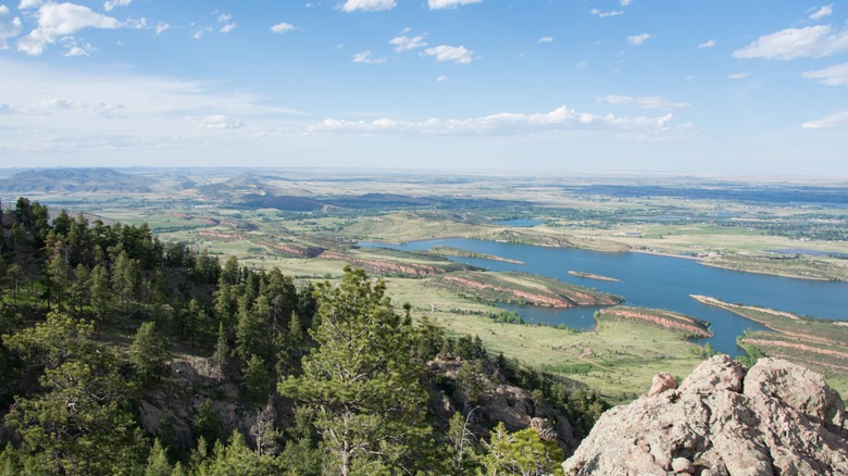 A rocky mountain summit overlooks a lake at Lory State Park, in Colorado.