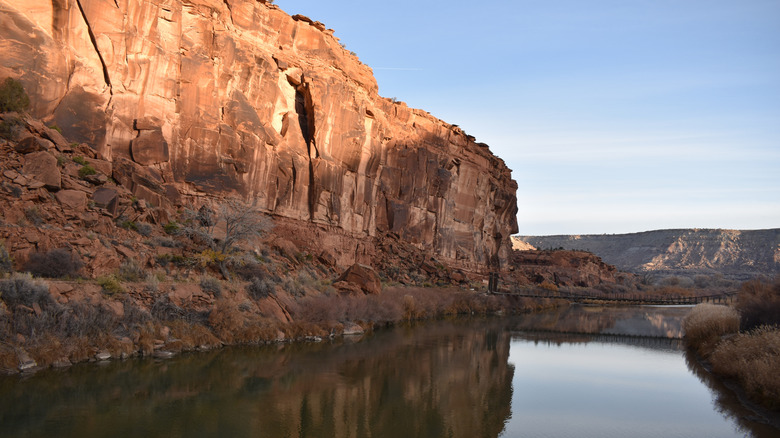 A red-rock bluff rises up over the Gunnison River, CO