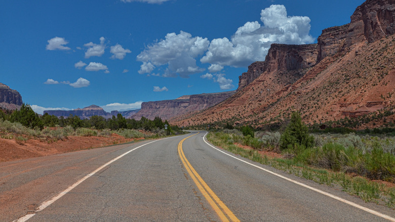 The Unaweep Tabeguache scenic byway runs below red-rock bluffs