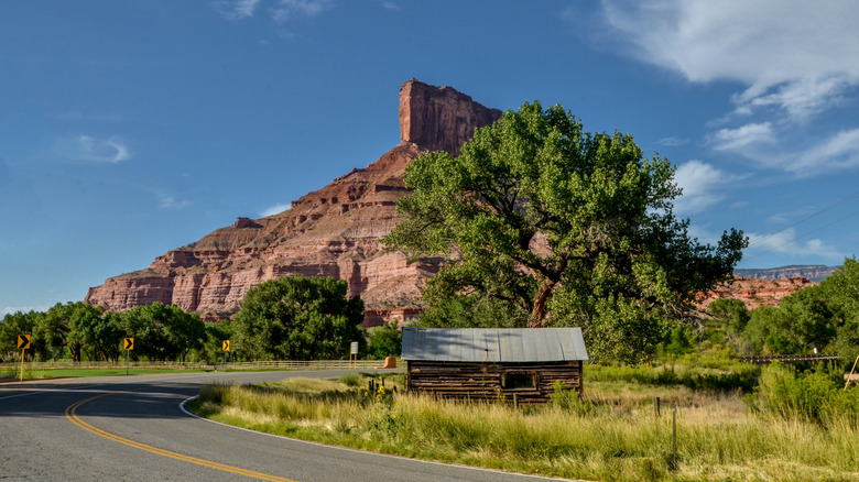 A cabin sits under a mountain on the Unaweep Tabeguache byway