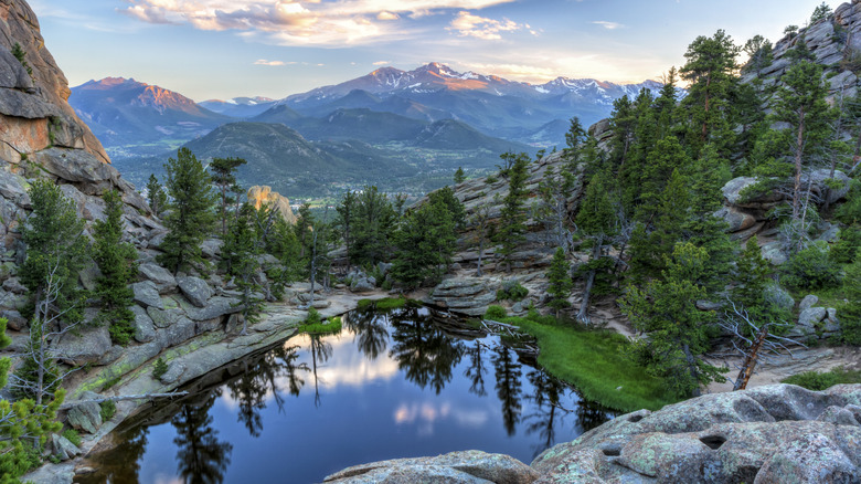Rocky outcroppings and mountains above a lake in Rocky Mountain National Park