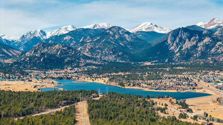 Snow-capped mountains tower above Estes Park in Larimer County, Colorado